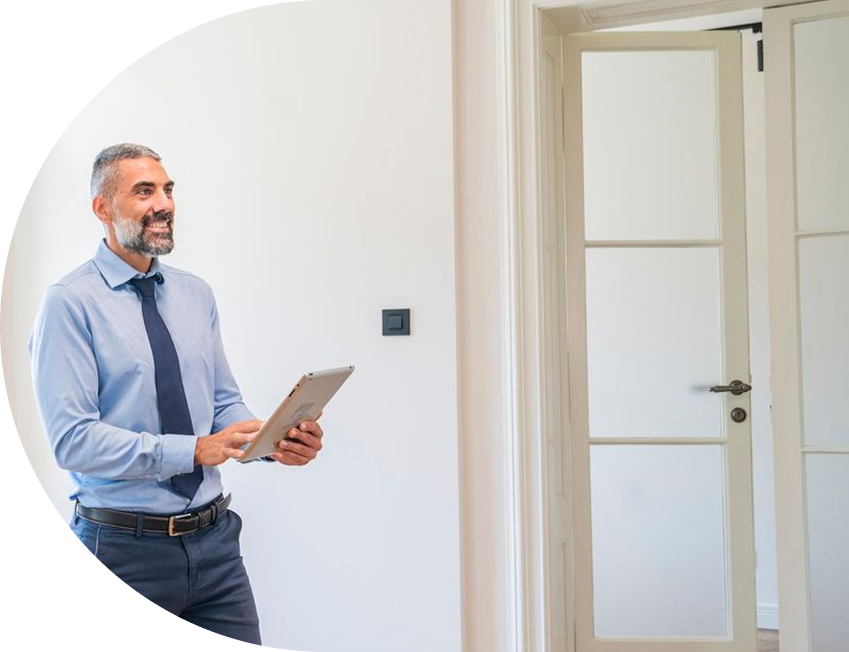 Property manager using a tablet to complete a digital inspection in a modern apartment